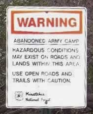 Warning: Abandoned Army Camp. Use open roads and trails with caution